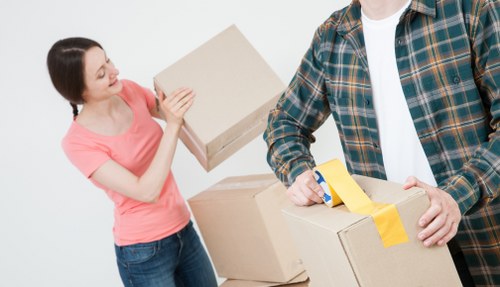 Loading household furniture into a moving truck in Earls Court