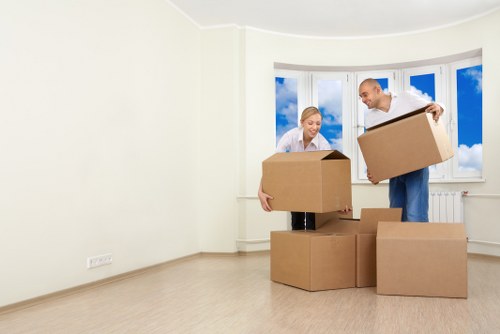 Removal team preparing items with protective packing and safety equipment