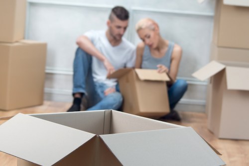 Professional movers loading office equipment in Earls Court